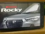 Hands replacing a map SD card in a Toyota Raize dashboard with close-up of NSZN-Y70D card