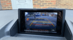 Lexus CT200h B9063 pop-up screen showing functional reverse backup camera with color parking guidelines and English warning: Check surroundings for safety.