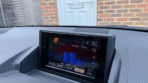 Lexus CT200h B9063 screen displaying Harmonious Driving Navi with ECO Level globe, fuel consumption bar chart in km per liter, and trip info tabs in English.
