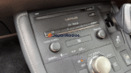 Lexus CT200h center console showing B9063 radio model stamp on top-left bezel and center microSD HC card slot door for 86271-76020 navigation card.
